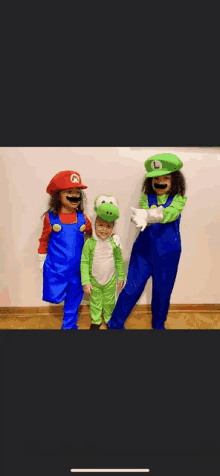 three children dressed as mario luigi and yoshi