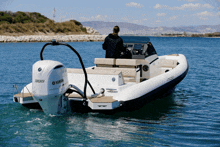 a white boat with a yamaha motor on the back