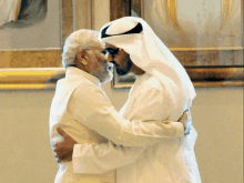 two men hugging each other in front of a framed picture