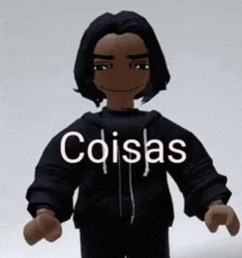 a doll with long black hair is wearing a black hoodie with the word cosas written on it .