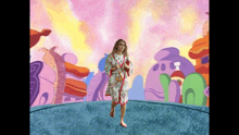 a woman in a robe stands in front of a colorful cartoon background