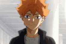 a close up of a boy with orange hair and a black jacket