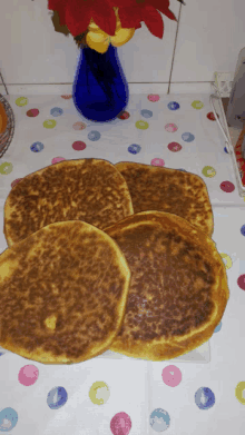 four pancakes are sitting on a white plate on a table