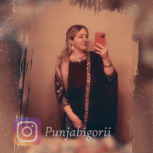 a woman taking a picture of herself with a punjabigorii logo in the background