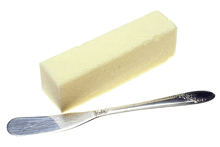 a stick of butter next to a knife with a floral design