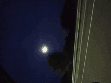 a full moon shines brightly in the night sky