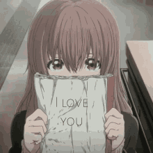 a girl is holding a book that says i love you