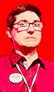 a man wearing glasses and a red shirt with a name tag that says ' chris ' on it