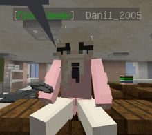 a girl in a pink sweater is sitting on a wooden table in a room with the name dani1 2005 on the bottom