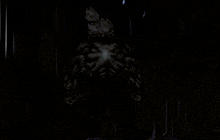 a silhouette of a monster in a dark room with a light shining on it