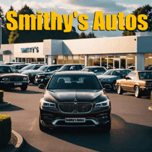 a car is parked in front of a smithy 's auto dealership