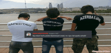 three men wearing shirts that say azerbaijan are pointing at something