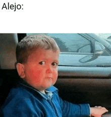 a little boy with red spots on his face is sitting in a car with alejo written on the bottom