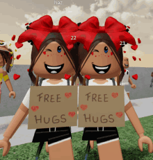 two girls holding signs that say free hugs