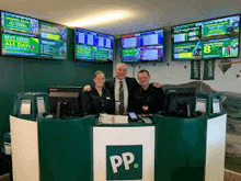 a group of people are posing for a picture in front of a pp counter .