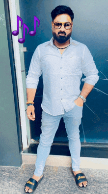 a man wearing a white shirt and blue jeans stands in front of a door