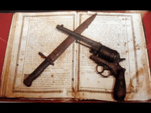 an old book with a gun and a knife on top of it