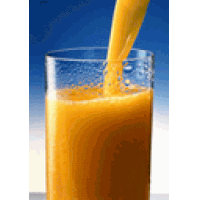 orange juice is being poured into a glass with a blue background