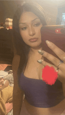 a woman taking a selfie with a cross necklace