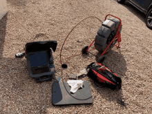 a drain camera is sitting next to a tool bag