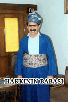 a man with a mustache is wearing a blue outfit with the words hakkinin babasi underneath him