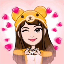 a girl wearing a teddy bear hat is making a heart with her hands