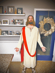 a man dressed as jesus in front of a wreath