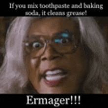 a woman with glasses is making a funny face while holding a toothpaste and baking soda .