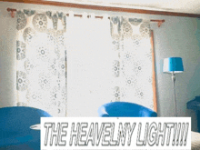 a living room with two blue chairs and a lamp and a sign that says the heavenly light !!!