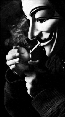 a man wearing a anonymous mask is smoking a cigarette in a black and white photo .