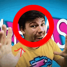 a man wearing a yellow shirt with a pixelated bird on it is surrounded by a red circle