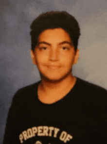 a young man wearing a black shirt with the word property on it