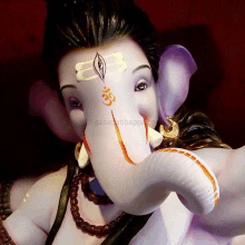 a close up of a statue of ganesha with the word ganapatibappa on the bottom right corner