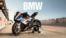 a bmw motorcycle is parked on the side of a race track