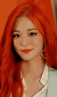 a woman with red hair is wearing earrings and a white shirt