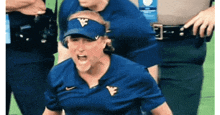 a woman wearing a blue shirt with a visor that has the letter w on it