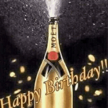 a bottle of champagne is being sprayed with the words `` happy birthday '' written on it .