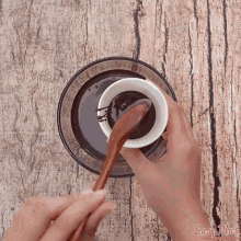 a person stirring a bowl of liquid with a wooden spoon and the words easy plus on the bottom right