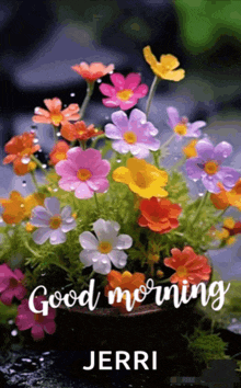 a bouquet of colorful flowers in a pot with the words good morning written on it