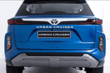 a blue toyota urban cruiser is shown from the back