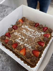 a chocolate cake with strawberries and the words happy 35th birthday from july