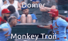 a baseball player is running towards another player with the words domer monkey troii below him