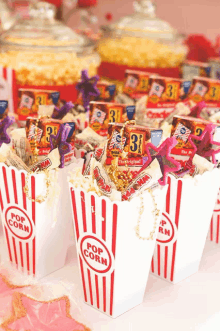 a row of popcorn containers filled with popcorn and candy with the number 3 on the front