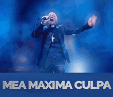 a man singing into a microphone with the words mea maxima culpa written below him