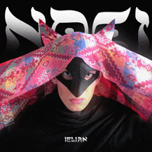 a woman wearing a black mask and a colorful scarf has the name ellian on the bottom