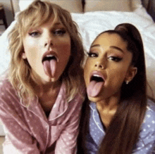 taylor swift and ariana grande are sticking their tongues out together .