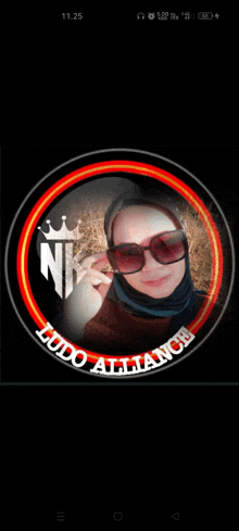 a woman wearing sunglasses and a hijab is surrounded by a logo that says ludo alliance