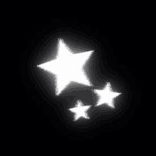 three white stars on a black background are floating in the air