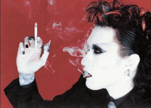 a woman smoking a cigarette with a tattoo on her arm