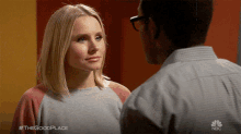 a man and a woman are looking at each other with #thegoodplace written on the bottom of the image